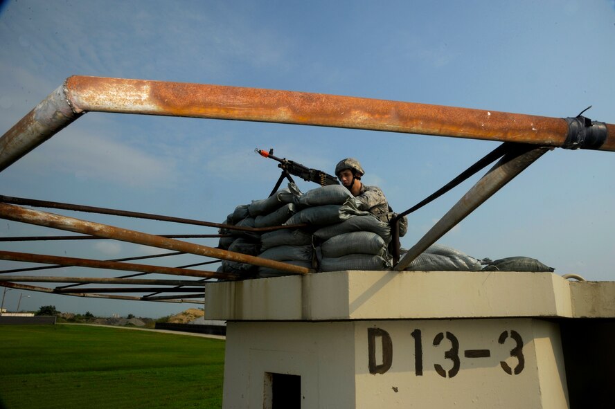 KUNSAN AIR BASE, Republic of Korea – Airman 1st Class Brunson Tanoa, 8th Security Forces Squadron response force member, watches over the area during exercise Beverly Midnight 13-3, Aug. 5, 2013 at Kunsan Air Base, Republic of Korea. Exercises like these play an integral role in maintaining base-readiness and ensuring the Wolf Pack is always ready to take the fight North. (U.S. Air Force photo by Staff Sgt. Jessica Haas/Released)