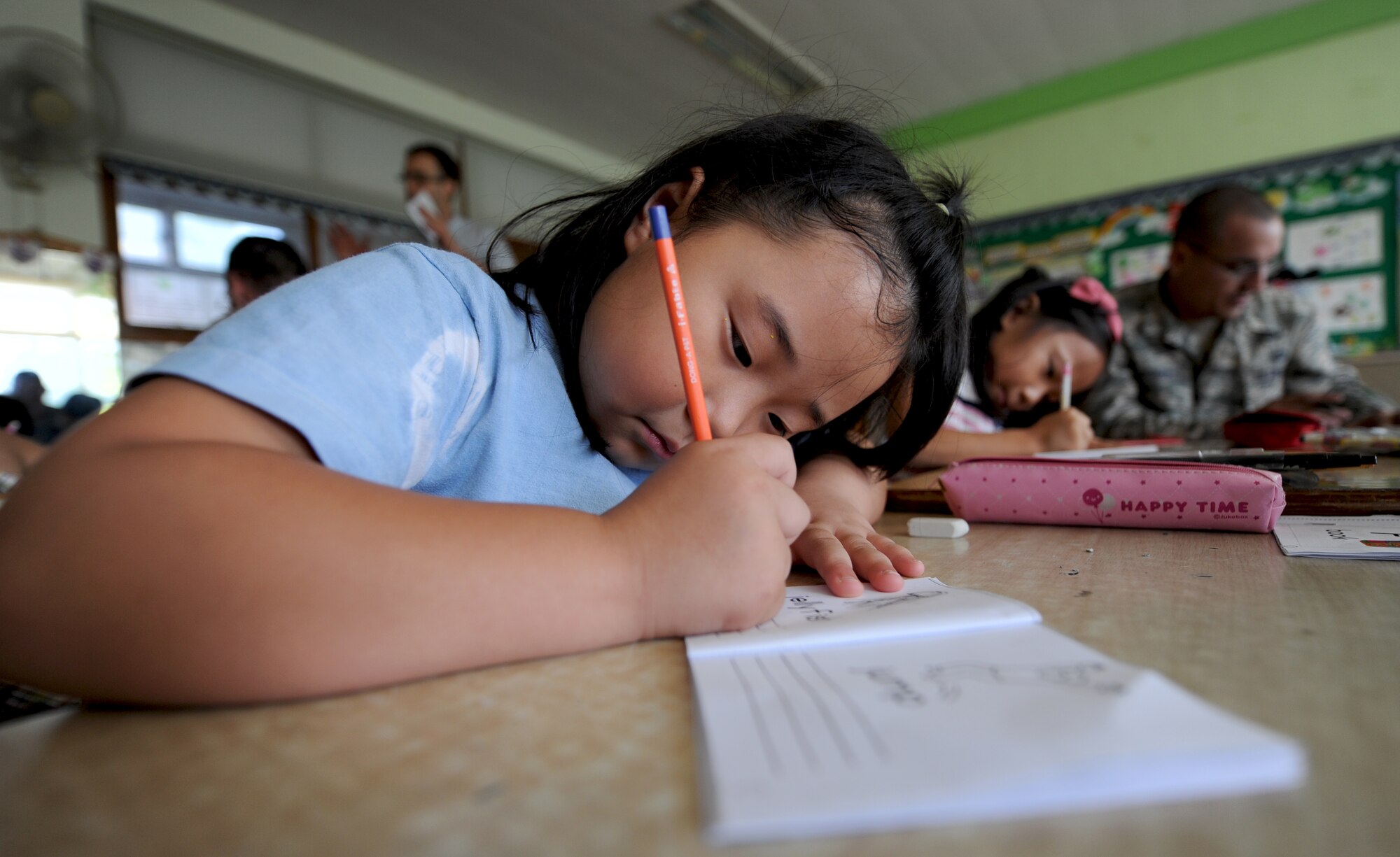 A child from the Kyesung-Elementary School in Pyeongtaek-si, Gyeonggi-do, Republic of Korea, finishes a workbook lesson that helps her learn the English alphabet during a visit from Airmen with the Detachment 2, 607th Weather Squadron located at Camp Humphreys, ROK, Aug. 1, 2013. The two Airmen from the weather squadron spent the morning with the children, teaching them about what they do as weather forecasters for the U.S. Air Force and helping them with their English. U.S service members throughout the peninsula visit with members of the local ROK community to help better understand each other’s cultures and enhance international relationships. (U.S. Air Force photo/Staff Sgt. Sara Csurilla)  (U.S. Air Force photo/Staff Sgt. Sara Csurilla)