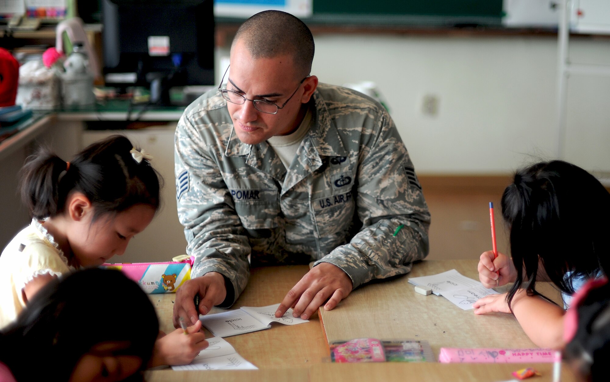 Staff Sgt. James Pomar, battlefield weather forecaster with Detachment 2, 607th Weather Squadron located at Camp Humphreys, helps children learn the ABCs at the Kyesung-Elementary School in Pyeongtaek-si, Gyeonggi-do, Republic of Korea, Aug. 1, 2013. Pomar and another member of his team visited the elementary school to teach the children about their job as U.S. Air Force weather forecasters and to help them better learn English. Visits like these help build stronger relationships and friendships between America and the ROK. (U.S. Air Force photo/Staff Sgt. Sara Csurilla)