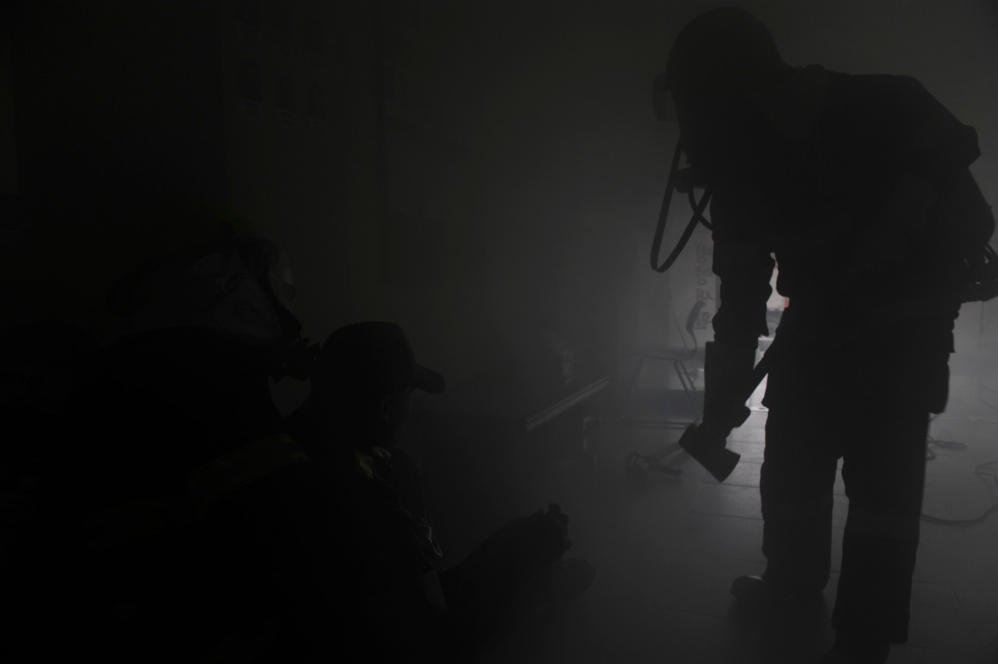 KUNSAN AIR BASE, Republic of Korea – Republic of Korea air force, 38th Fighter Group firefighters, prepare to drag a ROKAF airman to safety during exercise Beverly Midnight 13-3, Aug. 5, 2013. The liquid smoke provided ROKAF and U.S. Air Force first responders a realistic training scenario during a simulated electrical fire in the ROKAF dormitories. (U.S. Air Force Photo by Staff Sgt. Tong Duong/Released)