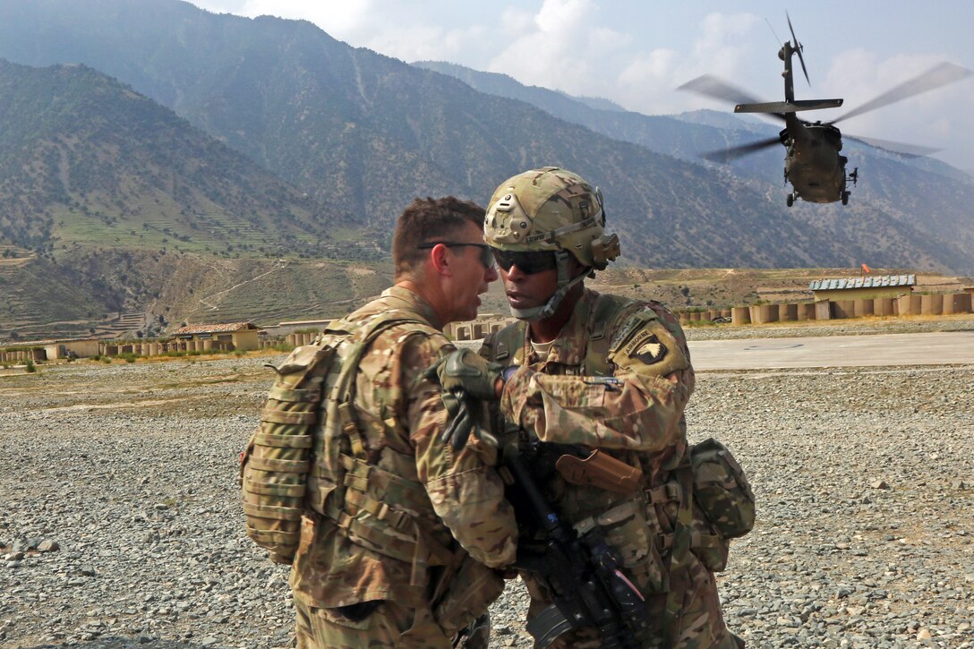 U.S. Army Col. J.P. McGee, left, greets U.S. Army Brig. Gen. Roland F. Lewis, right, the deputy commanding general for support, before a meeting on Forward Operating Base Bostic in Nuristan province, Afghanistan, July 28, 2013. McGee is commander of the 10th Mountain Division's 1st Brigade Combat Team.
