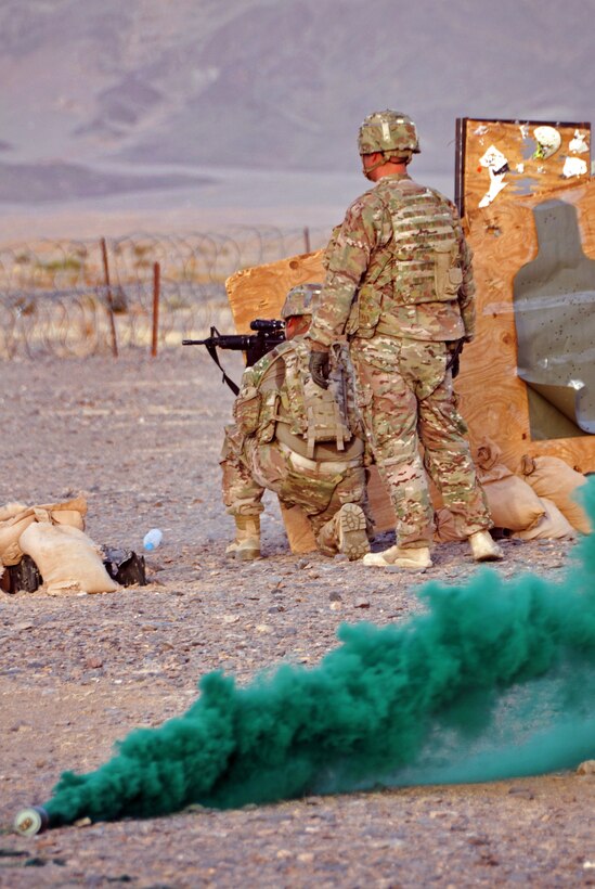 U.S. Army Staff Sgt. Michael Heimann, right, observes another soldier firing his weapon during a small arms range training exercise on Forward Operating Base Farah, Afghanistan, July 31, 2013. Heimann is assigned to Provincial Reconstruction Team Farah.