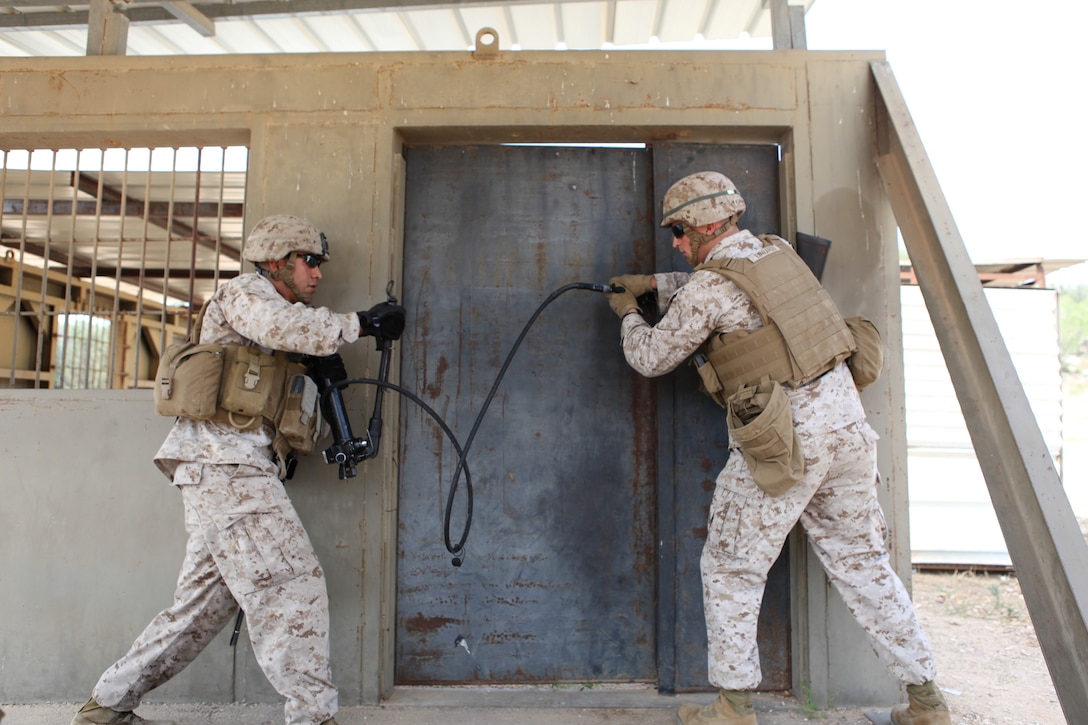 U.S. Marine Corps Cpl. Leopoldo Gonzalez (left), combat engineer, and 1st Lt. Colin Edwards, anti-terrorism/force protection officer with Black Sea Rotational Force 13 prepare to cold breach a door during a breaching course with the Israel Defense Force’s Counter-Terrorism Unit during exercise Noble Shirley 13 aboard Camp Adam, Israel, July 8, 2013.  The purpose of Noble Shirley 13 is to improve interoperability, understanding and cooperation between the IDF and U.S. Marines.  (U.S. Marine Corps photo by Staff Sgt. David Rakes, Sr./released)