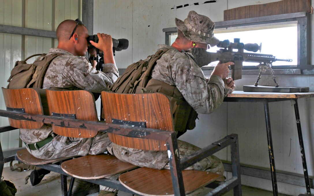 U.S. Marine Corps Lance Cpl. William Green III, a rifleman with Black Sea Rotational Force 13 spots for Cpl. Ryan Maniscalco, a Scout Sniper with BSRF-13, during a designated marksman exercise July 7, 2013 aboard Camp Adam, Israel, during Exercise Noble Shirley 13.  The live fire training exercise was conducted to familiarize the Marines with the tactics and techniques of the IDF. (U.S. Marine Corps photo by Lance Cpl. Michael Dye/released)