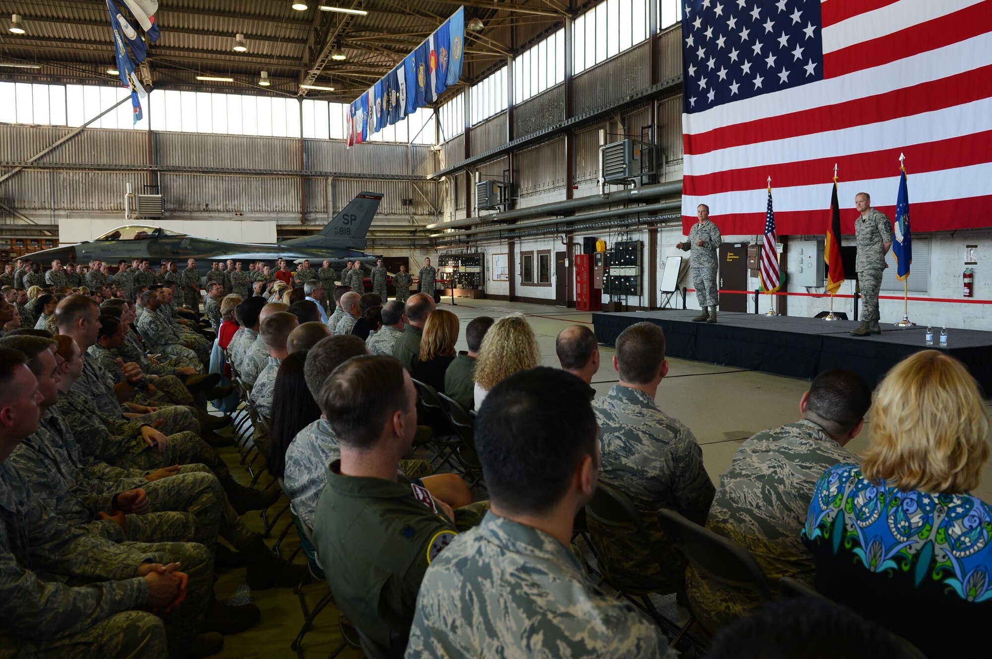 Air Force Chief of Staff Gen. Mark A. Welsh III and Chief Master Sgt. of the Air Force James Cody stand center stage in Hangar 1, addressing Airmen about Air Force issues during an Airman’s call Aug. 1, 2013. The senior leaders visited the base to thank Airmen and their families for their service and dedication, as well as address current challenges facing the Air Force. 