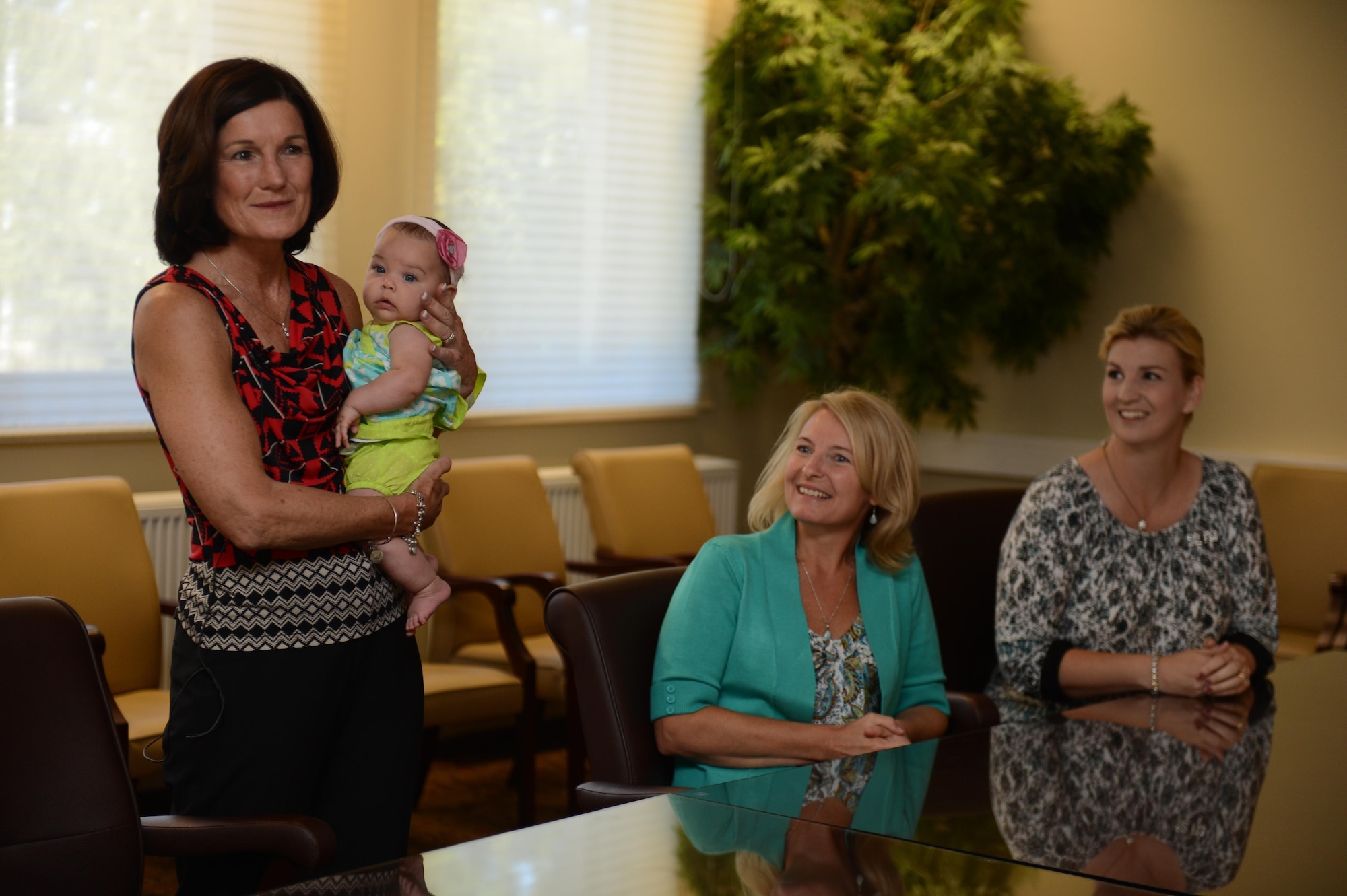 Betty Welsh and Athena Cody, spouses of Air Force Chief of Staff Gen. Mark A. Welsh III and Chief Master Sgt. of the Air Force James Cody, meet with military spouses Aug. 1, 2013. Throughout the visit, Welsh and Cody talked to the spouses about the dynamics of military families and their support of military members.