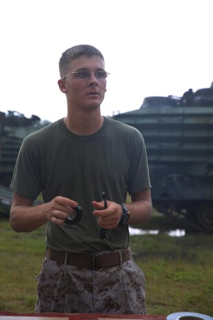 Cpl. Jacob A. Richardson, a combat engineer with 8th Engineer Support Battalion, 2nd Marine Logistics Group, creates a doughnut charge, which will be used to remove a doorknob while breaching a door during a field exercise aboard Camp Lejeune, N.C., July 29, 2013. The battalion trained with 2nd Assault Amphibian Battalion, 2nd Marine Division on the basics of urban and field demolitions. 