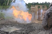 An explosive charge set by Marines with 8th Engineer Support Battalion, 2nd Marine Logistics Group detonates against a wall during a field operation aboard Camp Lejeune, N.C., July 29, 2013. The Marines trained with members of 2nd Assault Amphibian Battalion, 2nd Marine Division on the creation and use of urban and field explosives. 