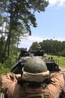 A Marine with 2nd Assault Amphibian Battalion, 2nd Marine Division waits for his convoy of Assault Amphibious Vehicles to depart during a field operation aboard Camp Lejeune, N.C., July 29, 2013. The unit joined 8th Engineer Support Battalion, 2nd Marine Logistics group on a training exercise with explosive demolitions for urban and field environments. 