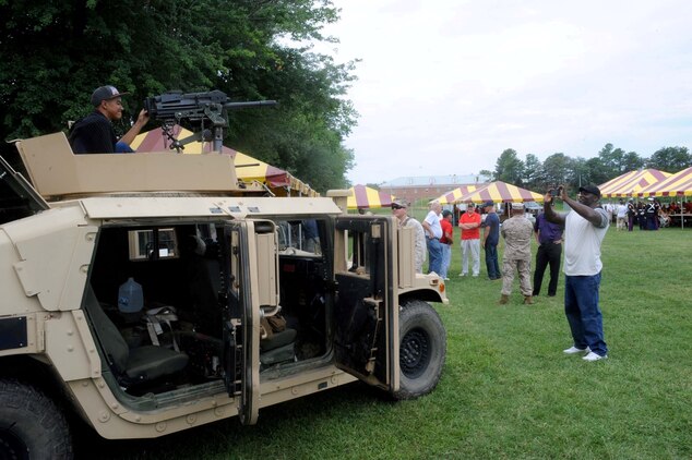 Guests visit the various displays at the Sergeant Major of the Marine Corps Picnic aboard Marine Corps Base Quantico on August 3, 2013. Several units including The Basic School, the Single Marine Program, the Provost Marshal’s Office and the Marine Corps Martial Arts Center for Excellence provided displays and demonstrations at the event.