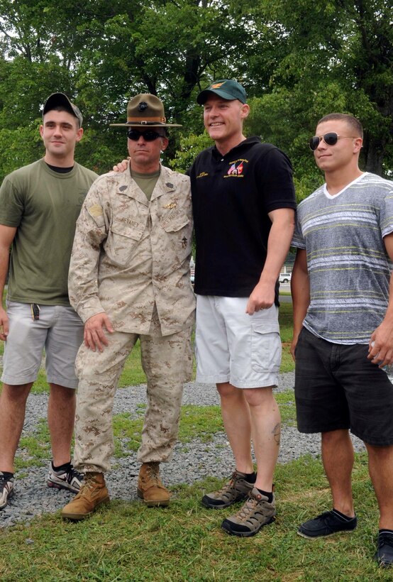 From the left, Connor Casey, Sgt. Maj. David Devaney, Sgt. Maj. Micheal Barrett and Lance Cpl. Ryan Connor pause for a photo at the Sergeant Major Picnic aboard Marine Corps Base Quantico on July 3, 2013. Over 200 guests participated in the 35th annual picnic.