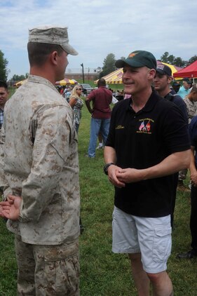 Sgt. Zachary Akers, combat instructor at The Basic School, talks with Sgt. Maj. Barrett,  sergeant major of the Marine Corps during the Sergeant Major Picnic aboard Marine Corps Base Quantico on Aug. 3, 2013. Several units including The Basic School, the Single Marine Program, the Provost Marshal’s Office and the Marine Corps Martial Arts Center for Excellence provided displays and demonstrations at the event.