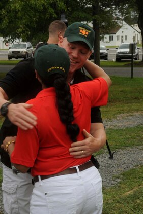 Sgt. Major Micheal Barrett, sergeant major of the Marine Corps, greets Sgt. Maj. Laura Brown, sergeant major of Marine Corps Base Quantico with a hug during the Sergeant Major Picnic aboard Marine Corps Base Quantico on Aug. 3, 2013. Barrett gave speech concerning the state of the Marine Corps to the hundreds of participants during the event.