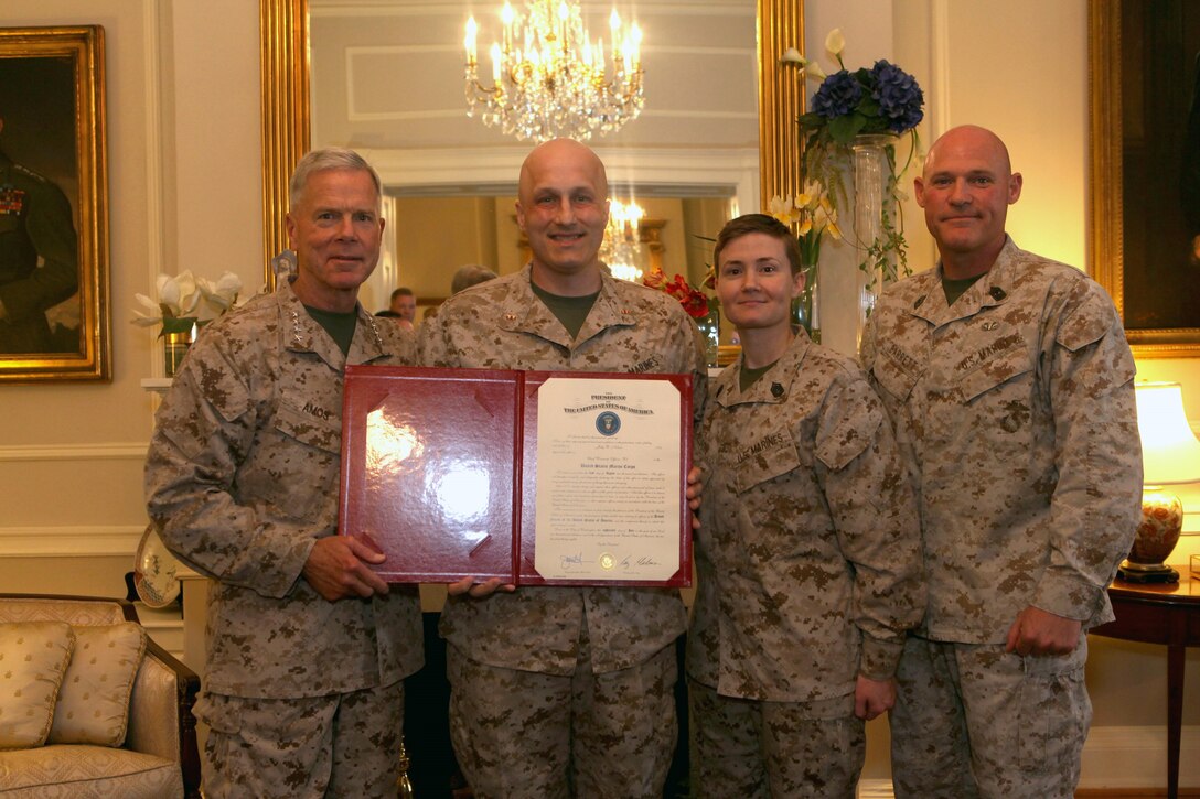 Gen. James F. Amos, the 35th Commandant of the Marine Corps, promotes Jody R. Nelson to the rank of Chief Warrant Officer 2 in the Home of the Commandants, Marine Barracks Washington, D.C., on Aug. 1, 2013. (U.S. Marine Corps photo by Sgt. Marionne T. Mangrum)