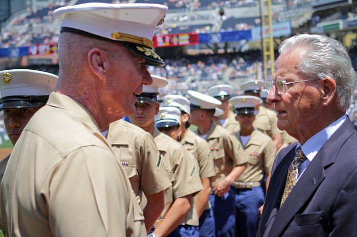 Lieutenant Gen. John Toolan Jr., the commanding general of I Marine Expeditionary Force, meets with Jerry Coleman, Major League Baseball Hall of Famer and Marine veteran who served in the Korean War and World War II, during San Diego Padres vs. New York Yankees game here, Aug. 4, 2013. Lieutenant Gen. Toolan, a native of Brooklyn, N.Y., threw out the ceremonial first pitch of the game in front of a sell-out crowd. Coleman served as a Marine aviator and flew more than 120 combat missions combined in both wars. He postponed his baseball career to serve in the Corps during WWII and left the MLB at the start of the Korean War to return to active duty. He played with the Yankees, managed the Padres and later became play-by-play radio announcer for the Padres.