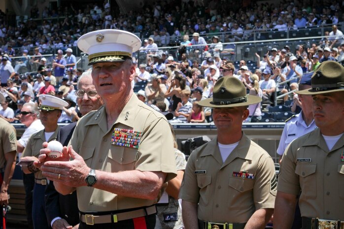 Lieutenant Gen. John Toolan Jr., the commanding general of I Marine Expeditionary Force, returns applause to a sell-out crowd at Petco Park here, Aug. 4, 2013, before throwing the ceremonial first pitch during the San Diego Padres vs. New York Yankees game. Baseball fans gave a standing ovation to Marines of 1st Marine Logistics Group, Marine drill instructors from Marine Corps Recruit Depot San Diego, and sailors of the USS Carl Vinson who lined the baseball diamond just before the start of the game.