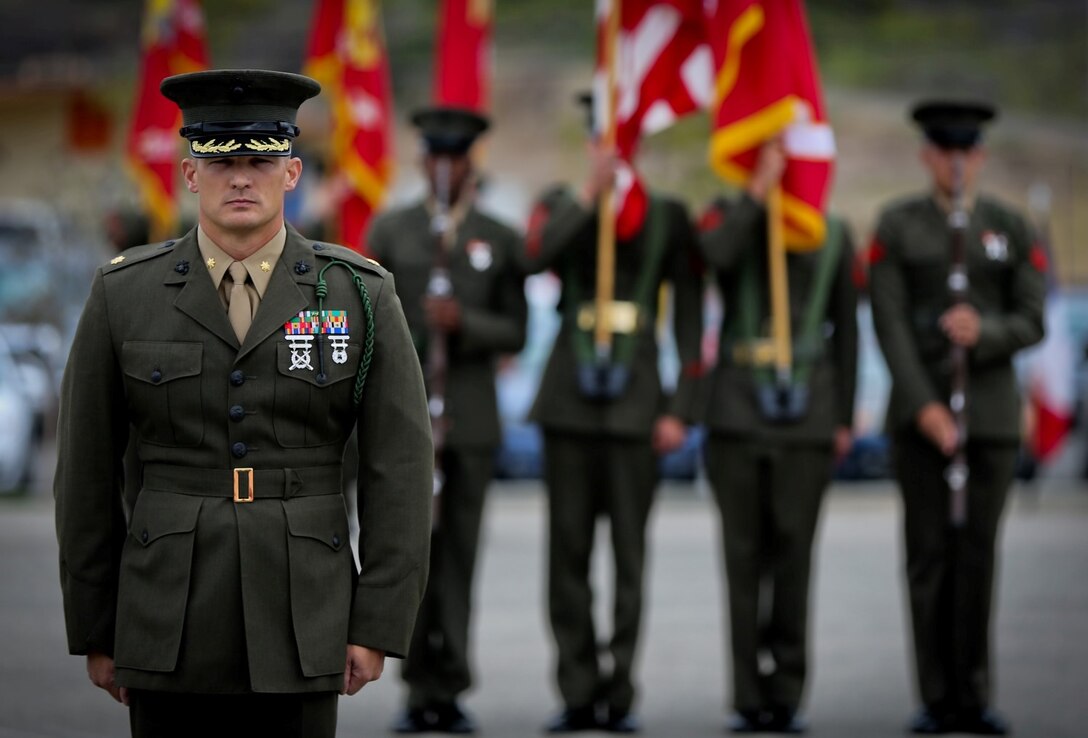 Major Scott A. Gehris, operations officer, 5th Marine Regiment, stands at attention during a French Fourragere ceremony aboard the Camp San Mateo parade deck here, Aug. 1, 2013. The regiment is one of two Marine Corps regiments authorized to wear the fourragere for heroic actions during World War I. The ceremony emphasized the Marines' commitment to upholding the rich history of the Fighting Fifth.