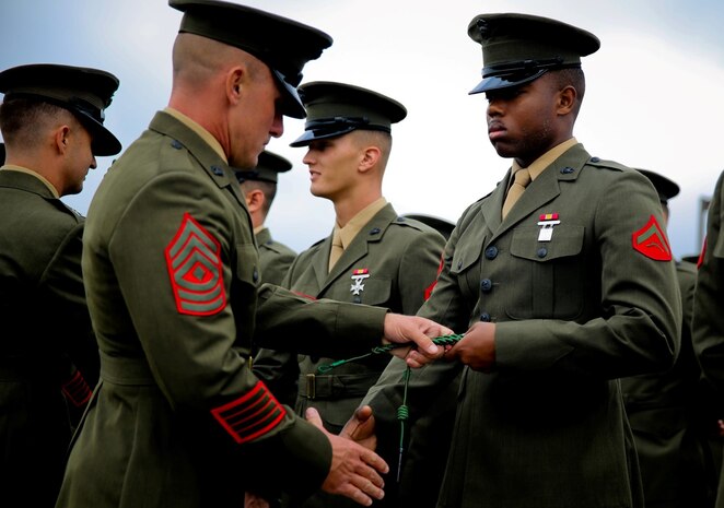 Marines with 5th Marine Regiment are presented the French Fourragere during a ceremony aboard the Camp San Mateo parade deck here, Aug. 1, 2013. The regiment is one of two Marine Corps regiments authorized to wear the fourragere for heroic actions during World War I. The ceremony emphasized the Marines' commitment to upholding the rich history of the Fighting Fifth.