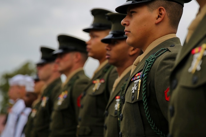 Marines and sailors with 5th Marine Regiment wear the French Fourragere on their left shoulders during a ceremony aboard the Camp San Mateo parade deck here, Aug. 1, 2013. The regiment is one of two Marine Corps regiments authorized to wear the fourragere for heroic actions during World War I. The ceremony emphasized the Marines' commitment to upholding the rich history of the Fighting Fifth.