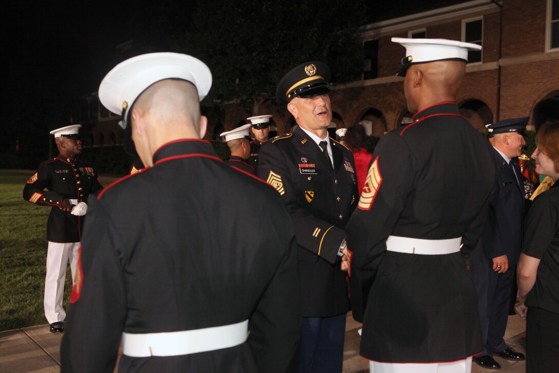 Sgt. Maj. Micheal P. Barrett, the 17th Sergeant Major of the Marine Corps, hosts the evening parade in honor of the 14th Sergeant Major of the Army Sgt. Maj. Raymond F. Chandler, the 13th Master Chief Petty Officer of the Navy Master Chief Petty Officer Michael D. Stevens, and the 4th Senior Enlisted Advisor for the National Guard Bureau Chief Master Sgt. Mitchell O. Brush at the Marine Barracks Washington, D.C., on Aug. 2, 2013. (U.S. Marine Corps photo by Sgt. Marionne T. Mangrum)