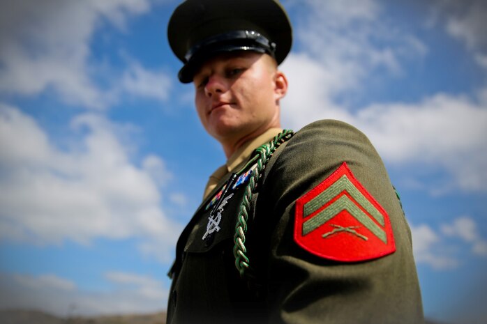 Corporal Genadiy Moskalenko, motor transportation operator, 1st Battalion, 5th Marine Regiment, wears his newly presented French Fourragere on his left shoulder after a ceremony aboard the Camp San Mateo parade deck, Aug. 1, 2013. The regiment is one of two Marine Corps regiments authorized to wear the fourragere for heroic actions during World War I. The ceremony emphasized the Marines' commitment to upholding the rich history of the Fighting Fifth.