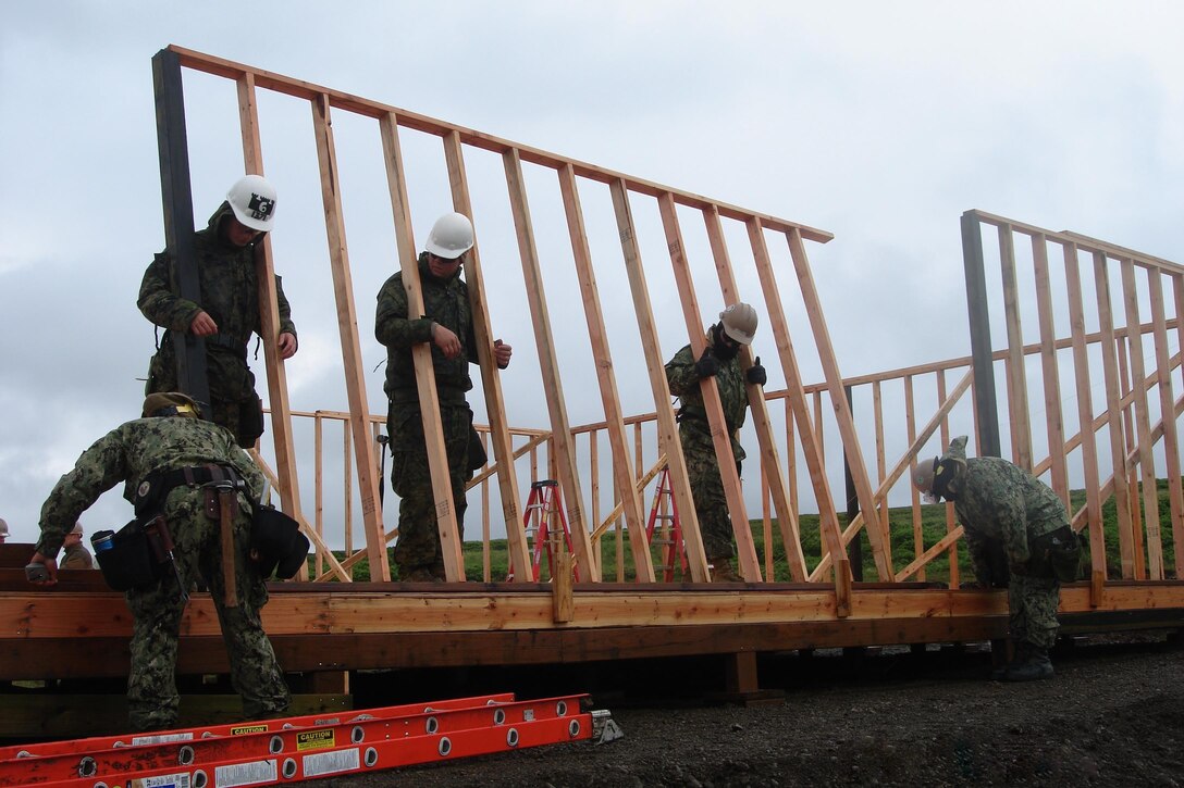 Marine Corps combat engineers from 6th Engineer Support Battalion, 4th Marine Logistics Group and SeaBees from Naval Mobile Construction Bn. 18 work side-by-side in the construction of a 32 x 64 foot structure in support of Innovative Readiness Training Mertarvik, here July 3. IRT Mertarvik was a Marine-led, five-year, joint-service, training opportunity for Reserve components of all the branches of the U.S. military to hone their humanitarian skills, community relations and austere-condition operation capabilities, while supporting the relocation of a local Alaskan people due to rising waters, an eroding riverbank and flooding in their village. (U.S. Marine Corps photo by Capt. Chad Hailey)