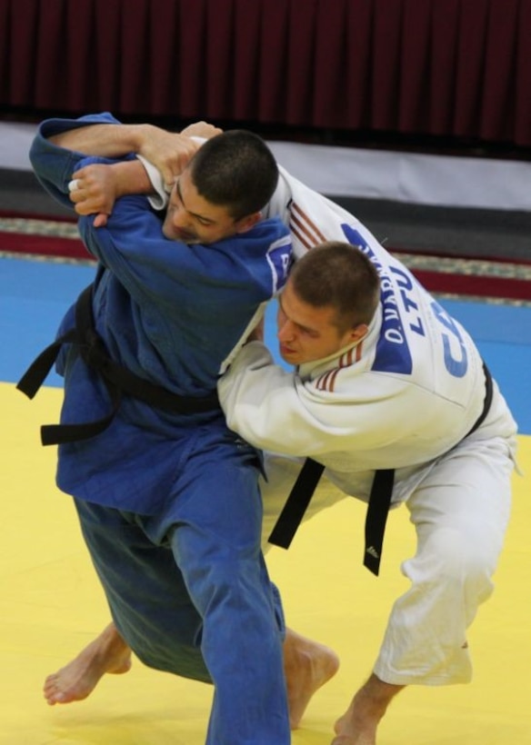 Air Force 1st Lt. Akira Nervik attempts to throw his opponent from Lithuania at the 2013 CISM World Military Judo Championship in Astana, Kazakhstan 30 Jun to 7 July.