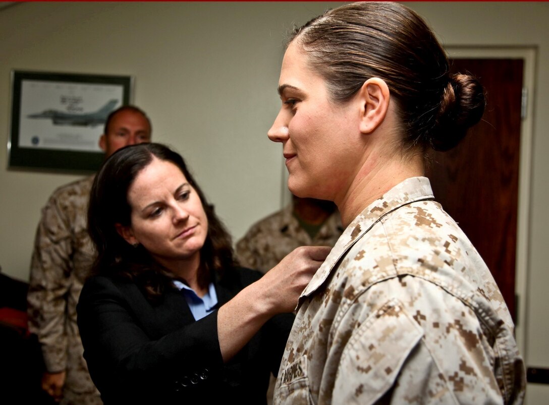 130805-M-ST621-012 MARINE CORPS BASE CAMP PENDLETON, Calif., -- (Aug. 5, 2013) Captain Vanessa Clark, pilot, Marine Helicopter Squadron 1, pins Maj. Janine Mills, adjutant, Command Element, 15th Marine Expeditionary Unit, with gold oak leaves during her promotion ceremony held in the unit’s conference room aboard Camp Pendleton, Calif., Aug. 5. Mills is from Granbury, Texas.  (U.S. Marine Corps Photo by Cpl. Emmanuel Ramos/Released)