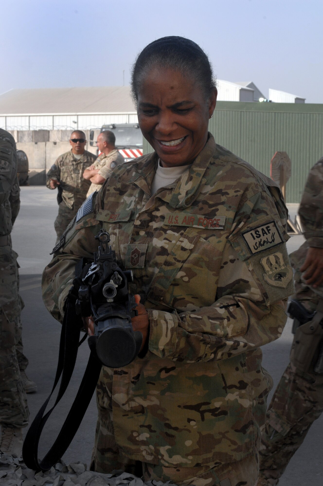 Chief Master Sgt. Shelina Frey, Command Chief Master Sergeant for U.S. Air Forces Central Command, examines a Belgian-designed weapon at Kandahar Airfield, Afghanistan, July 27, 2013. Frey visited KAF with Lt. Gen. John Hesterman III, Combined Force Air Component and AFCENT commander, as part of an orientation tour for the new CFACC. (U.S. Air Force photo/Senior Airman Jack Sanders) 