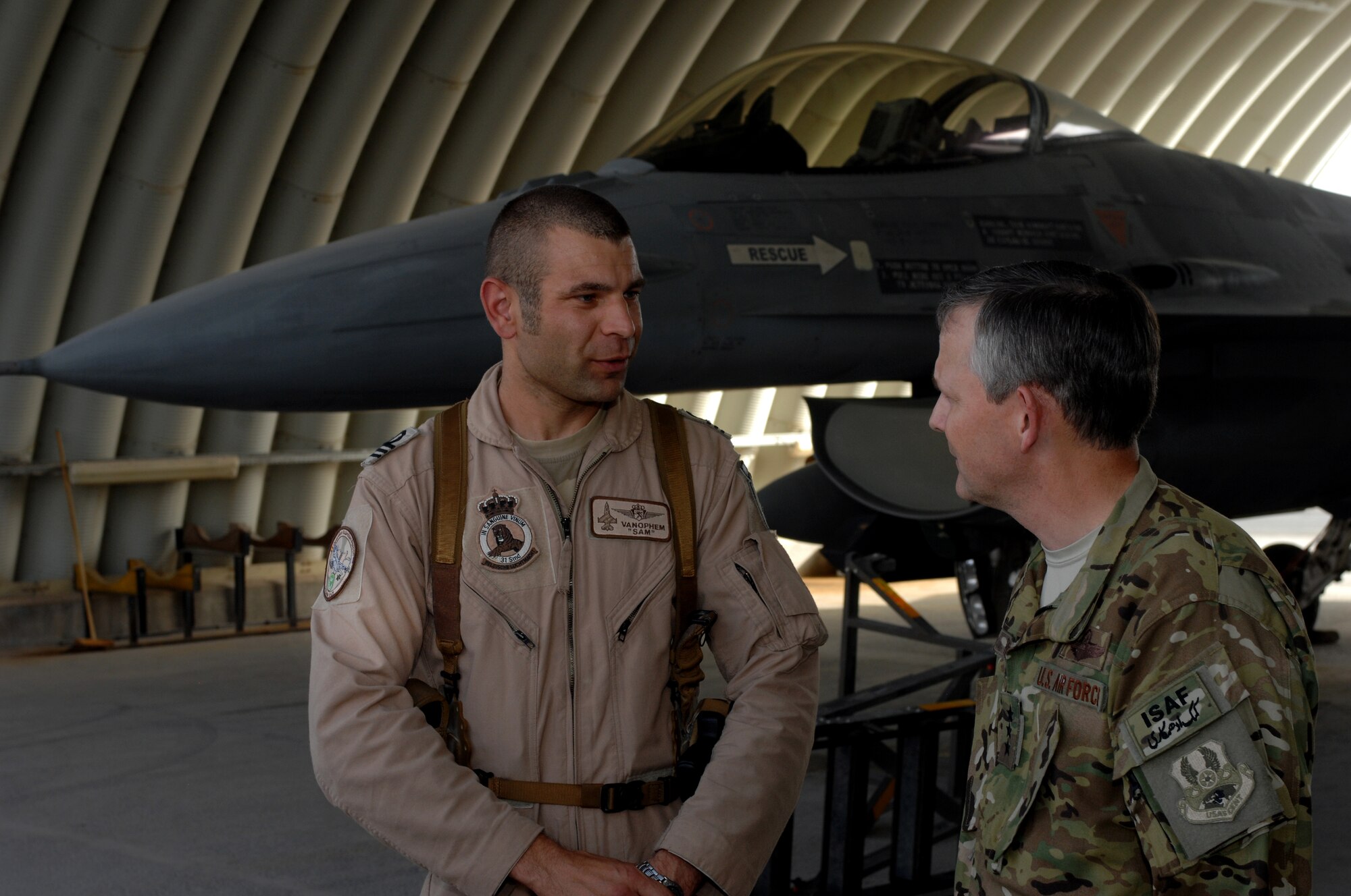 Senior Capt. Sammuel Vanophem, commander of the Belgian Armed Forces Air Component detachment at Kandahar Airfield, speaks with Lt. Gen. John Hesterman III as part of an orientation visit at Kandahar Airfield, Afghanistan, July 28, 2013. During his tour Hesterman spoke with Airmen and coalition forces about their mission and life here. (U.S. Air Force photo/Senior Airman Jack Sanders)