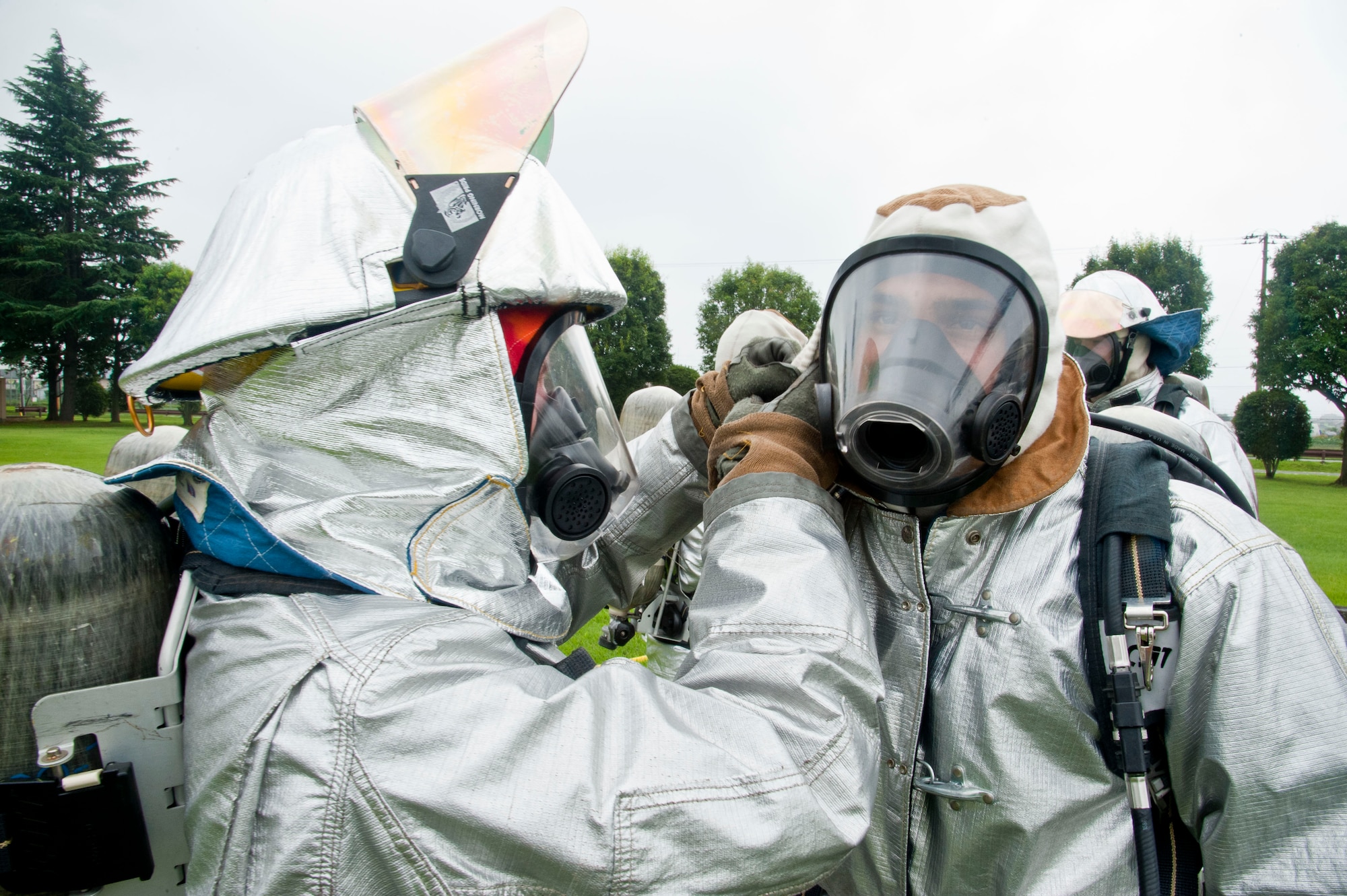 YOKOTA AIR BASE, Japan – A pair of Marines firefighters do buddy-checks before entering the simulated flashover trainer at Yokota Air Base, Japan, July 30, 2013.  Flashover is a dangerous situation which occurs when the heat caused by fire accumulates in the room and cause the smoke’s temperature rise to combustion.  (U.S. Air Force photo by Airman 1st Class Soo C. Kim)