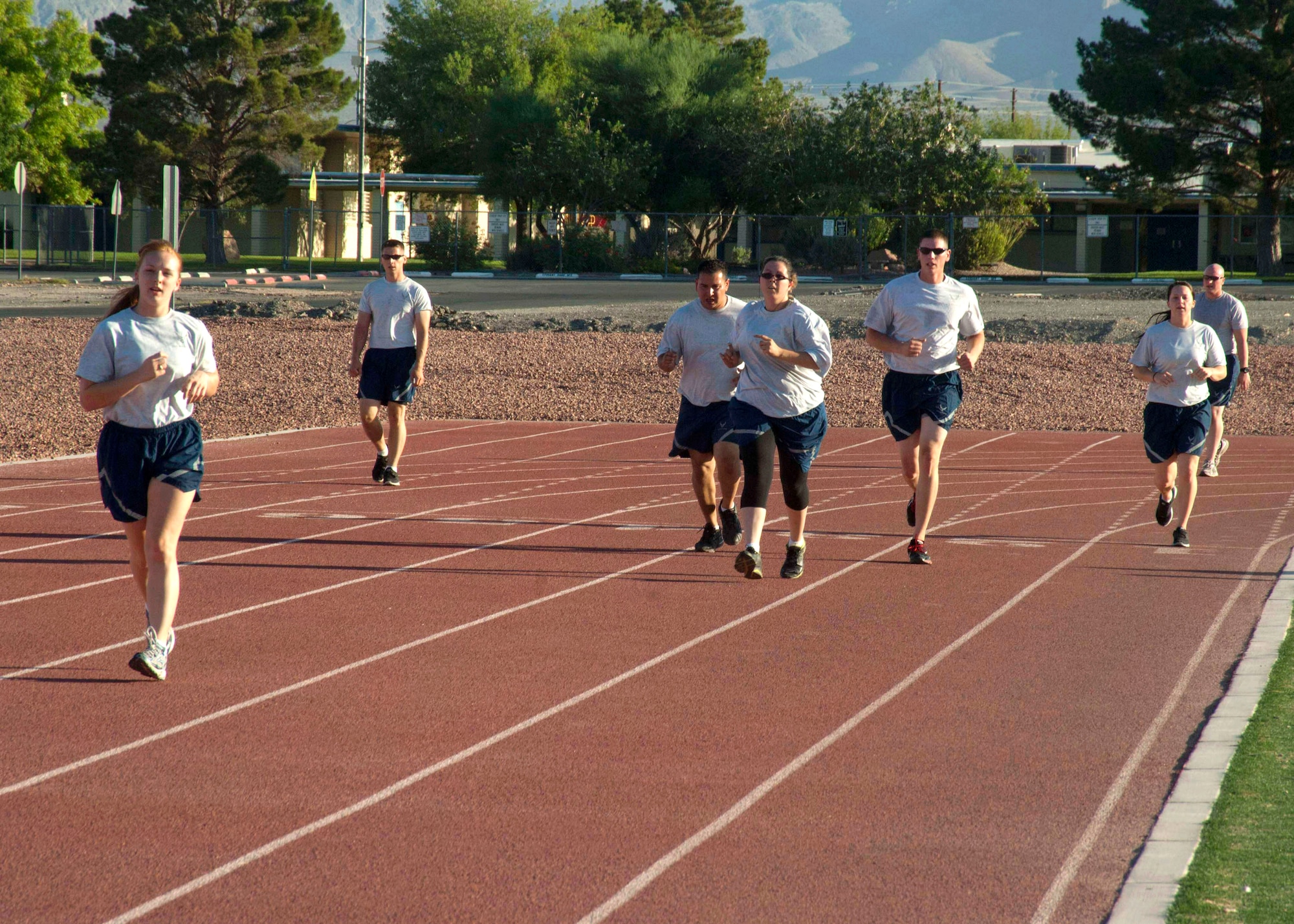 U.S Air Force Airmen run around the track located behind the Warrior Fitness Center Aug. 5, 2013, at Nellis Air Force Base, Nev. The Unit Fitness Program Managers no longer register Airmen for their annual or biannual physical fitness tests. Airmen are now responsible for scheduling their own tests electronically. (U.S. Air Force Photo by Airman 1st Class Timothy Young)