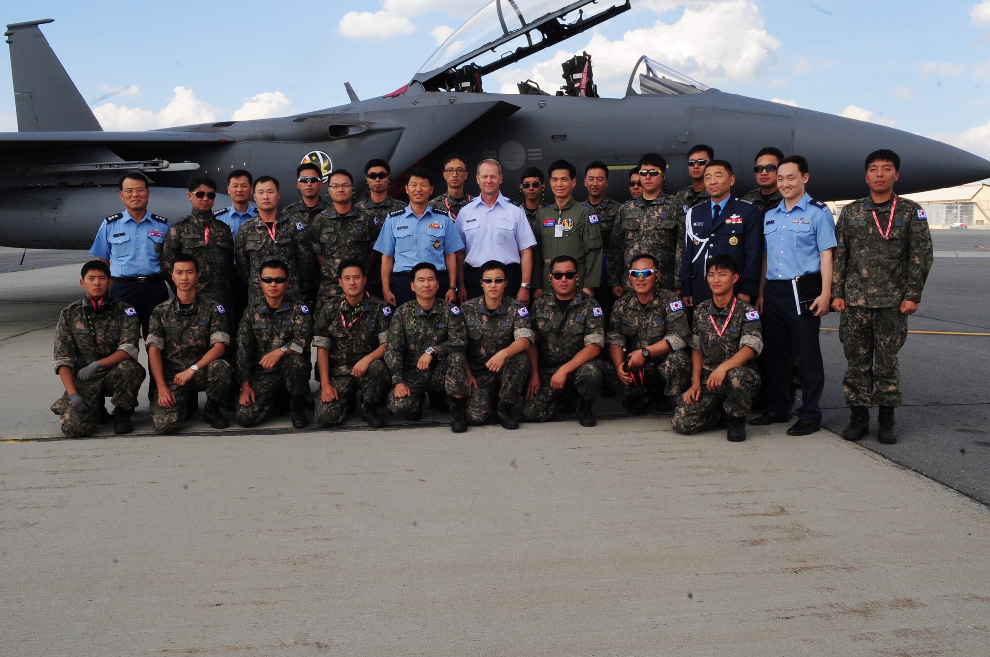 Gen. Ilhwan Sung, Republic of Korea Air Force chief of staff, and Brig. Gen. Mark Kelly, 354th Fighter Wing commander, pose for a group photo with Republic of Korea airmen Aug. 5, 2013, Eielson Air Force Base, Alaska. More than 120 airmen and six aircraft from Republic of Korea Air Force arrived to participate in RED FLAG-Alaska 13-3. (U.S. Air Force photo by Airman 1st Class Lauren-Taylor Levin/Released)