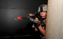 KUNSAN AIR BASE, Republic of Korea -- First Lt. Jared Goss, 8th Security Forces Squadron exercise mobile reserve leader, participates in a mock firefight during an exercise Aug. 8, 2013. Several Wolf Pack Airmen posed as opposition forces using blank cartridgesto increase the realism of exercise Beverly Midnight 13-3. (U.S. Air Force photo by Senior Airman Armando A. Schwier-Morales/ Released)