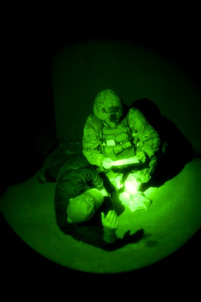 KUNSAN AIR BASE, Republic of Korea -- Airman 1st Class Anthony Kelly, 8th Security Forces Squadron, reads an inject card while apprehending a hostile invader during exercise Beverly Midnight 13-3, Aug. 7, 2013. Inject cards are used during exercises to convey information during a simulated scenario. (U.S. Air Force photo by Senior Airman Clayton Lenhardt/Released)