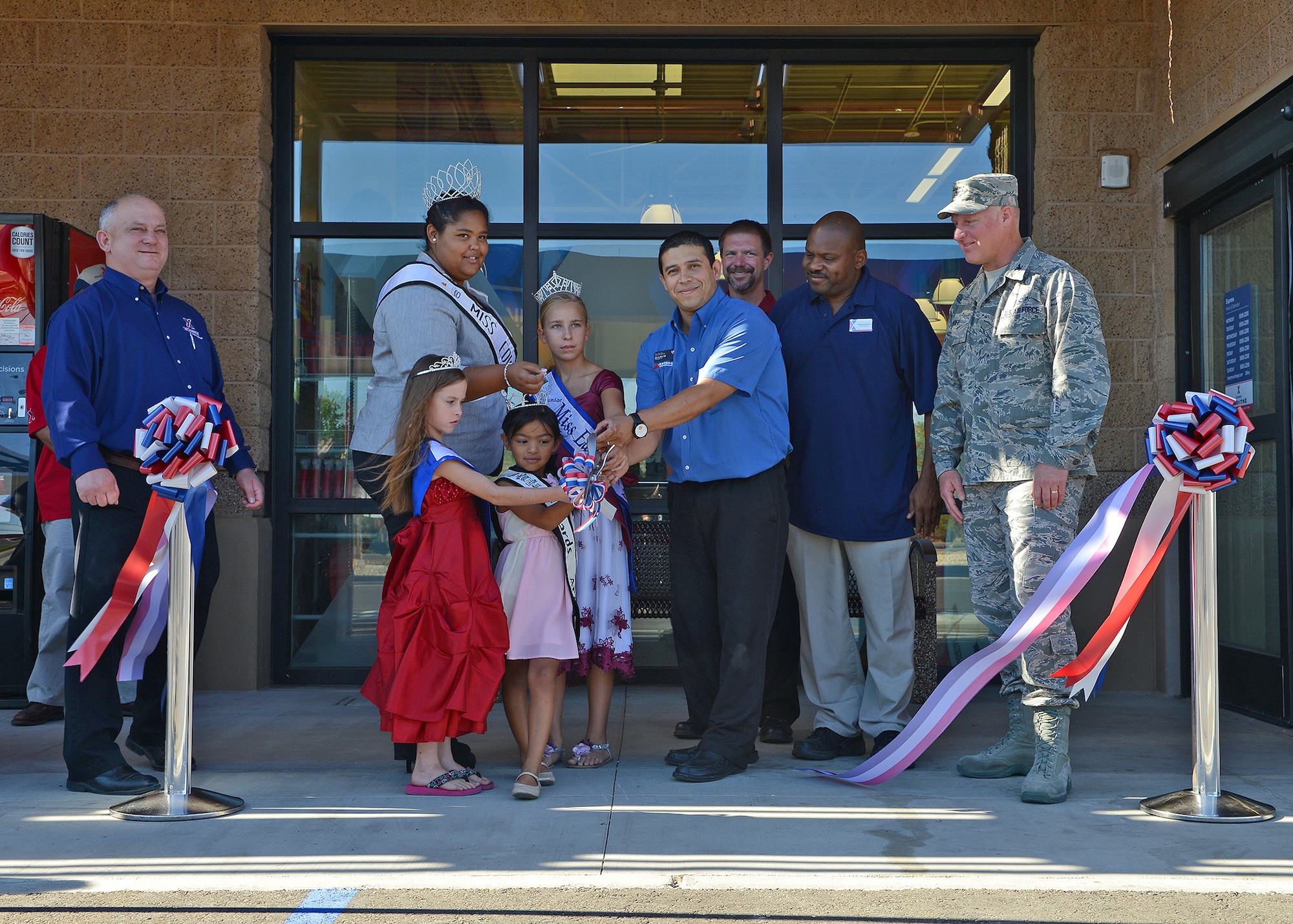 (From left to right) Mike Wiles, Edwards Exchange general manager; the Edwards Queens; Allan Mendez, Firestone general manager; Brian Caldwell, Bridgestone Western Zone senior marketing manager; Dennis Perkins, Edwards Car Care Center store manager, and Col. Robert Hoff, 412th Mission Support Group commander, were in attendance during the grand opening and ribbon cutting of Edwards' newest service station, the Express, Aug. 5, 2013. The Express had a week-long grand opening filled with festivities, special promotions and giveaways. (U.S. Air Force photo by Jet Fabara)