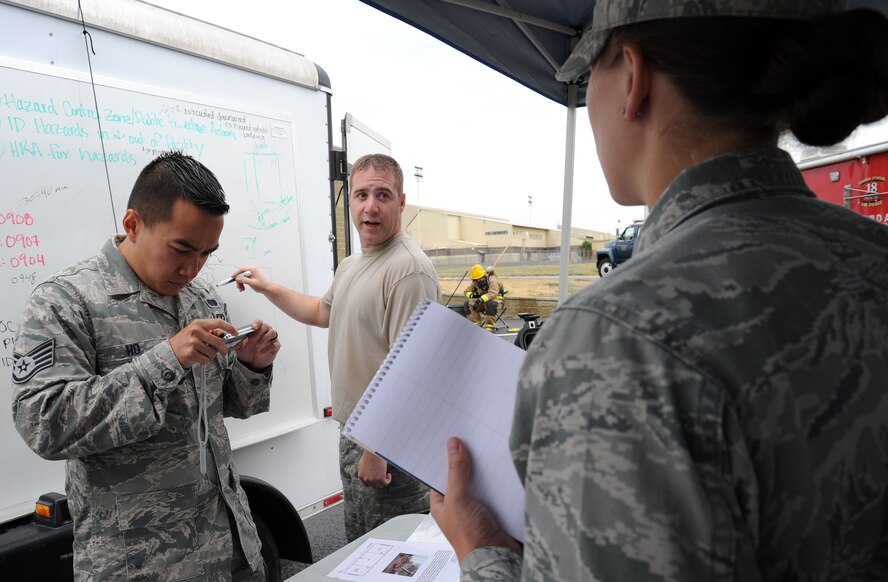 Staff Sgt. Jeremy Parks, 92nd Civil Engineer Squadron emergency management craftsman, explains what happened during a field exercise at Fairchild Air Force Base, Wash., Aug. 1, 2013. During the Integrated Base Emergency Response Capability Training field exercise, emergency responders increase their capabilities by learning and conducting Chemical, Biological, Radiological and Nuclear Defense (CBRN) focused vulnerability assessments, participating in first responder training, applying countermeasure and defense applications, utilizing appropriate personal protective equipment, and demonstrating proficiency with CBRN identification and analytical equipment and methodologies. (U.S. Air Force photo/Airman 1st Class Janelle Patiño)