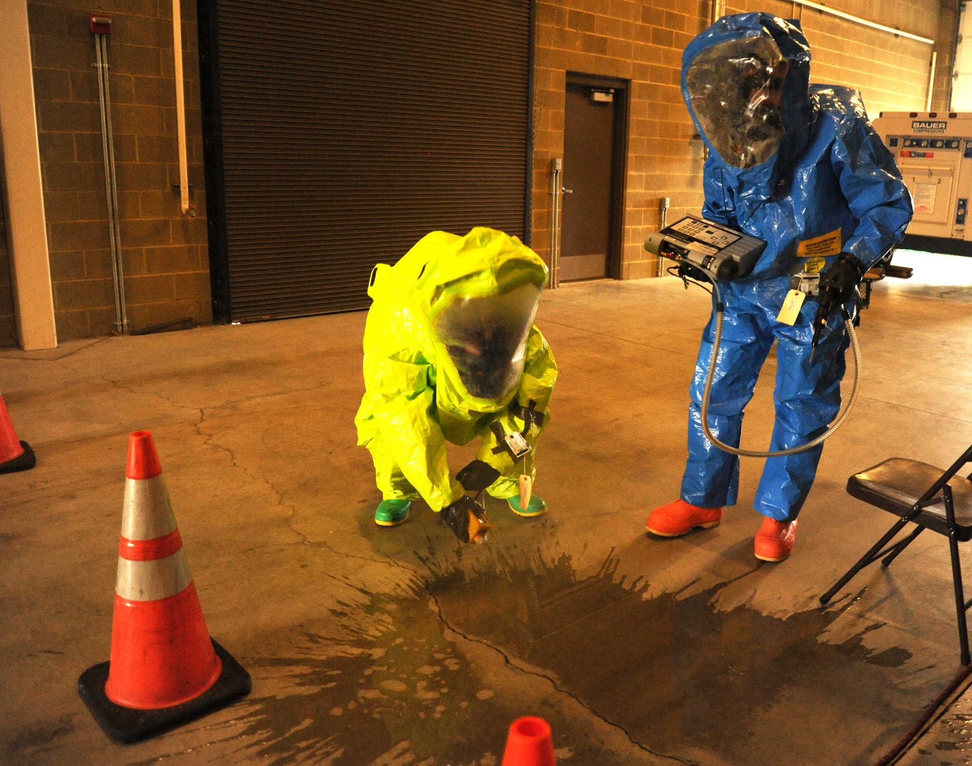 Staff Sgt. Jeremy Parks, 92nd Civil Engineer Squadron emergency management craftsman, and Senior Airman Adam Wriglesworth, 92nd Civil Engineer Squadron readiness journeyman, use the MultiRae and TVA-1000 devices to detect hypothetical hazards in the scenario building at Fairchild Air Force Base, Wash., Aug. 1, 2013.  The devices test for oxygen, carbon monoxide, hydrogen sulfide, lower explosive limits and volatile organic compounds for all chemicals.  (U.S. Air Force photo by Airman 1st Class Sam Fogleman/Released)