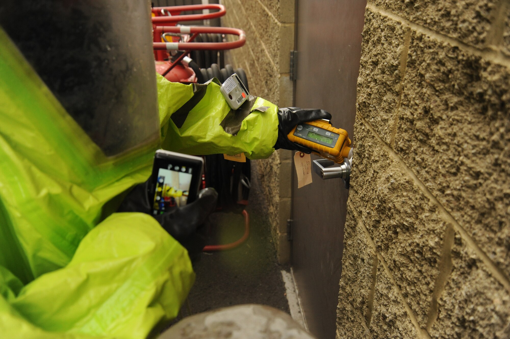 Staff Sgt. Jeremy Parks, 92nd Civil Engineer Squadron emergency management craftsman, uses a MultiRae device to detect hypothetical airborne contaminants before entering the scenario building at Fairchild Air Force Base, Wash., Aug. 1, 2013.  The safety verification was part of the Integrated Base Emergency Response Cabability Training exercise.  (U.S. Air Force photo by Airman 1st Class Sam Fogleman/Released)