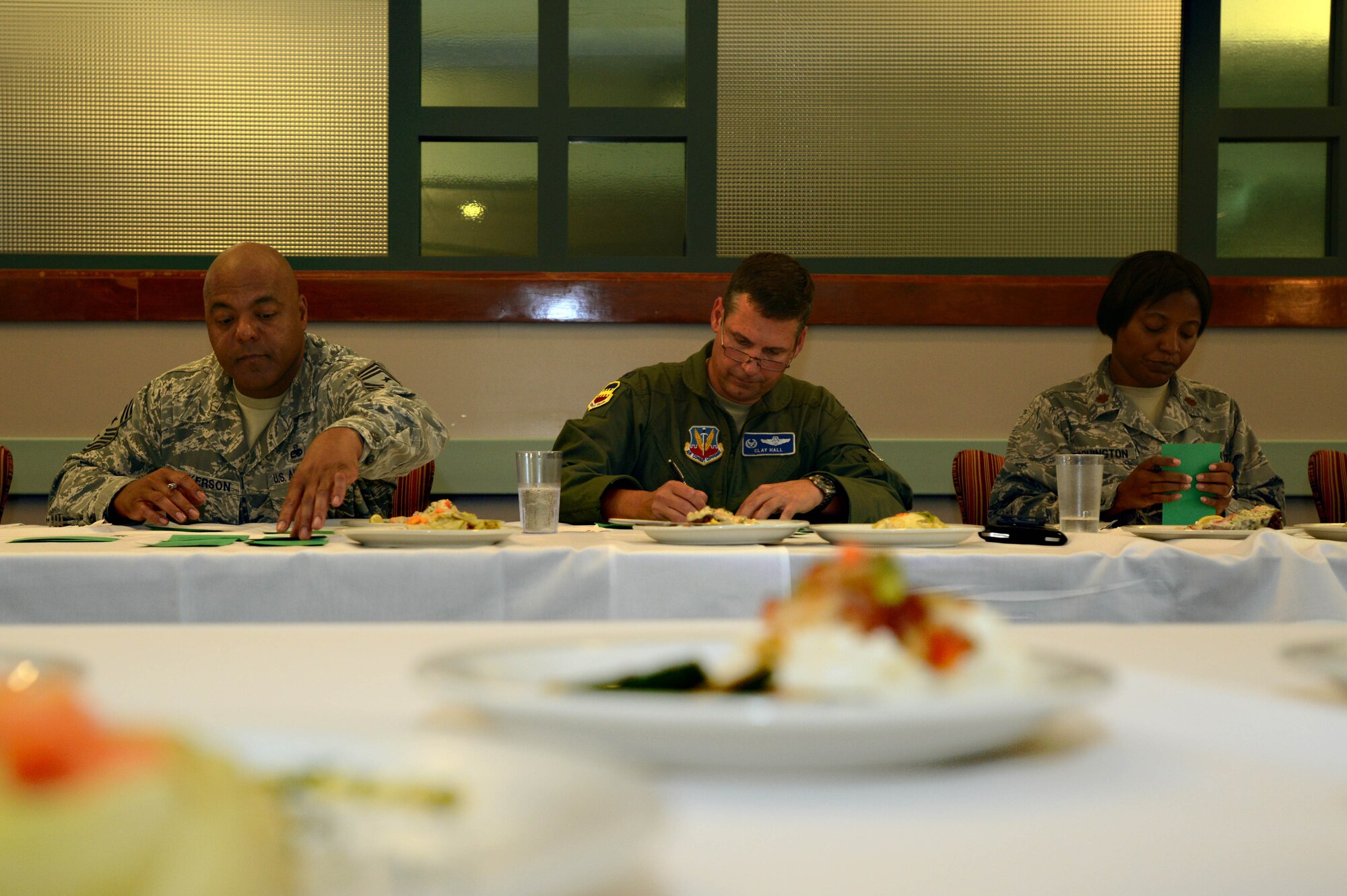 (From left) Chief Master Sgt. James Wilkerson, 20th Fighter Wing command chief, Col. Clay Hall, 20th FW commander, and Maj. Tonya Washington, U.S. Air Forces Central force support commander, judge food during an Iron Chef competition at the Chief Master Sgt. Emerson Williams Dining Facility, Shaw Air Force Base, S.C., July 30, 2013. The competition was judged on two dishes prepared with the secret ingredient of papaya. (U.S. Air Force photo by Airman 1st Class Jensen Stidham/Released) 
