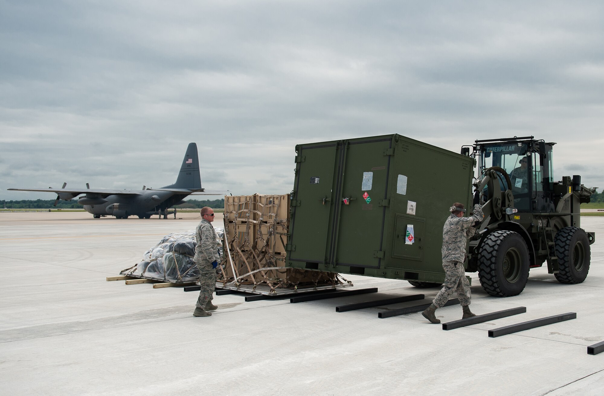 Airmen from the Kentucky Air National Guard’s 123rd Contingency Response Group marshal equipment at MidAmerica St. Louis Airport in Mascoutah, Ill., on Aug. 5, 2013, as part of Exercise Gateway Relief, a U.S. Transportation Command-directed earthquake-response scenario. The 123rd is joining forces with the U.S. Army’s active-duty 689th Rapid Port Opening Element from Fort Eustis, Va., to stand up and operate a Joint Task Force-Port Opening, which combines an Air Force Aerial Port of Debarkation with an Army trucking and distribution unit. The aerial port ensures the smooth flow of cargo and relief supplies into affected areas by airlift, while the trucking unit facilitates their final distribution over land. (U.S. Air National Guard photo by Maj. Dale Greer)