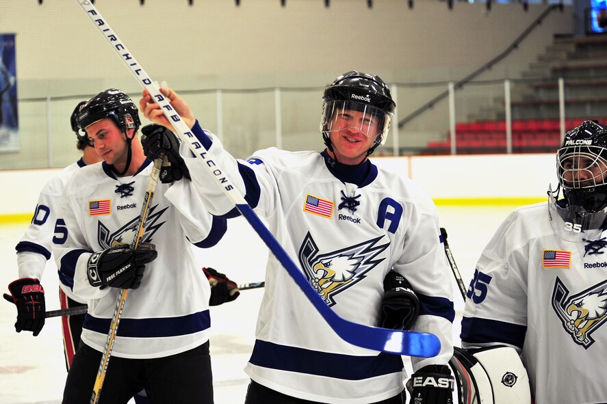 Maj. Brent Golembiewski, member of the Fairchild Air Force Base Falcons hockey team, receives a stick from the team as a farewell gift for the hard work he put into developing the team at Washington State University, Cheney, Wash., July 31, 2013. This was Golembiewski’s last skate with the team before leaving to his next duty station. (U.S. Air Force photo by Senior Airman Taylor Curry/Released)