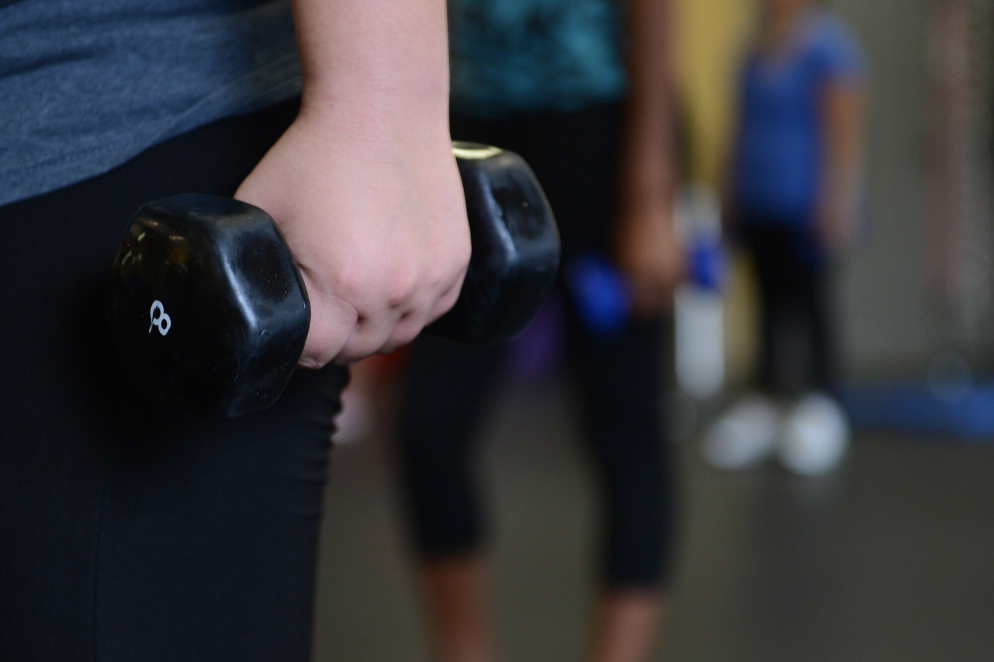 Members of Team Shaw practice interval weight training during a new aerobic fitness program, called Power Hour, at the fitness center, Shaw Air Force Base, S.C., Aug. 1, 2013. Participants in Power Hour will use different equipment like dumbbells, kettle bells, yoga balls and other similar equipment during the course of the free program. (U.S. Air Force photo by Airman 1st Class Krystal M. Jeffers/Released)