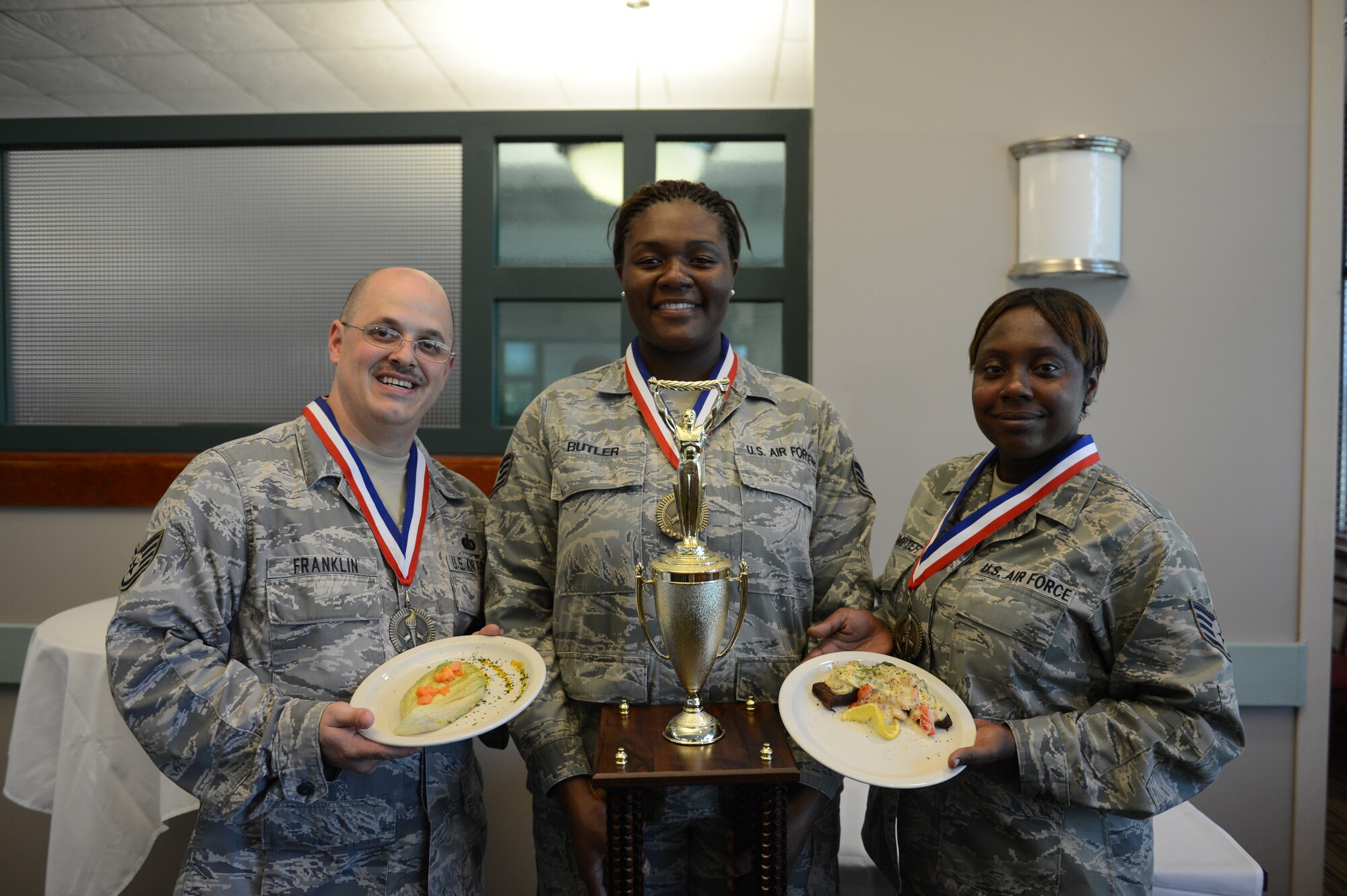 Staff Sergeants Matthew Franklin, Sethena Butler, and Adrienne Sumpter, 20th Force Support Squadron shift supervisors, won the Iron Chef competition at the Chief Master Sgt. Emerson Williams Dining Facility, Shaw Air Force Base, S.C., July 30, 2013. Three teams representing various Team Shaw units competed in the event. They had to make an appetizer and an entrée with the secret ingredient, papaya, in 90 minutes. (U.S. Air Force photos by Airman 1st Class Krystal M. Jeffers/Released)
