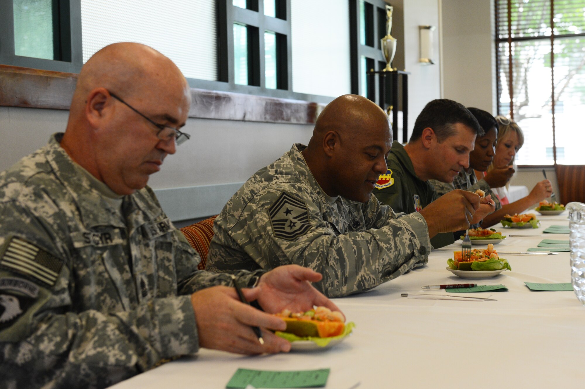 Team Shaw leadership act as food judges during the Iron Chef competition at the Chief Master Sgt. Emerson Williams Dining Facility, Shaw Air Force Base, S.C., July 30, 2013. The judges included Col. Clay Hall, 20th Fighter Wing commander; Sgt. Maj. Randy St. Cyr, Third Army/U.S. Army Central food services supervisor; and Maj. Tonya Washington, U.S. Air Forces Central force support commander. They blind tested each dish and then judged them on taste, plate presentation, creativity, originality and the incorporation of the secret ingredient into both dishes. (U.S. Air Force photo by Airman 1st Class Krystal M. Jeffers/Released) 