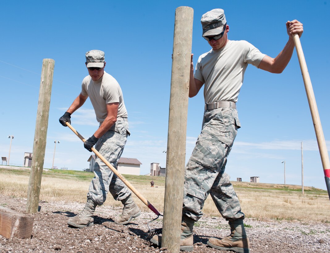 Staff Sgts. Raymond Zgoda (left) and Paul Terlop, 28th Civil Engineer Squadron heavy equipment and pavement technicians, level dirt and gravel during construction of the new archery range on Ellsworth Air Force Base, S.D., July 26, 2013. ¬¬¬The new range, operated by Outdoor Recreation, is located near the 28th Security Forces Squadron Combat Arms Training and Maintenance facility and features multiple targets at 10, 20 and 30 meters. For more information, contact Outdoor Recreation at (605) 385-2997. (U.S. Air Force photo by Senior Airman Kate Maurer/Released)