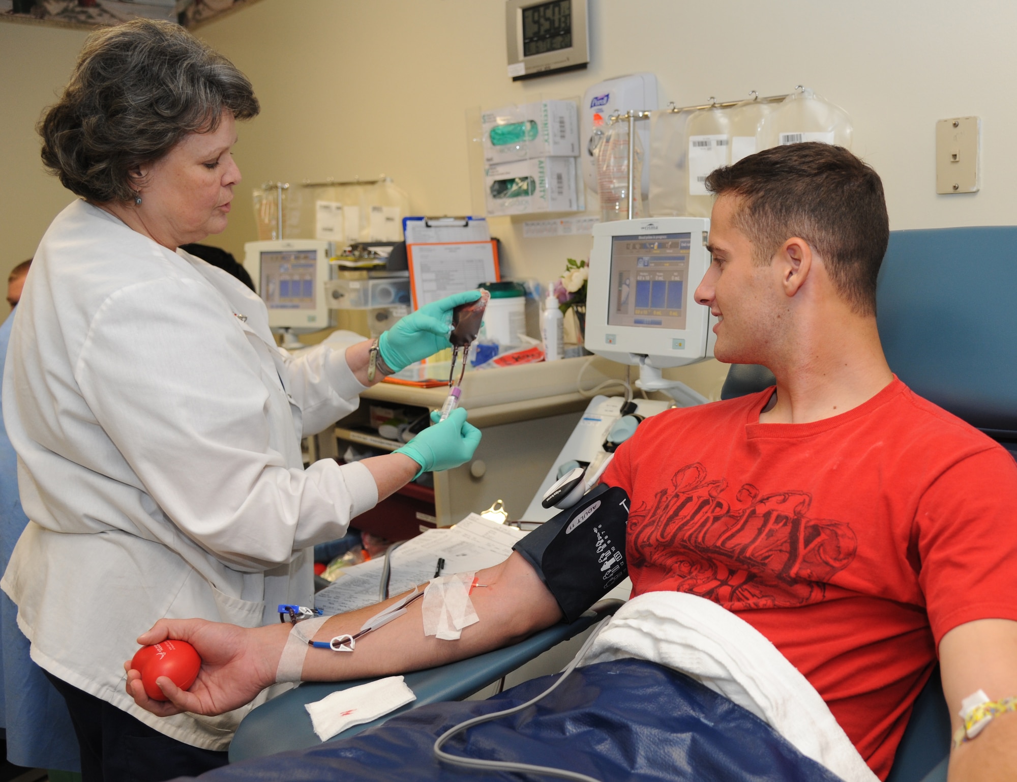 Rose Weatherly, 81st Diagnostic and Therapeutics Squadron registered nurse apheresis supervisor, transfers blood into tubes for testing during a apheresis platelet donor session given by Airman 1st Class Thomas Humphrey, 338th Training Squadron student.  Platelets may be required daily by leukemia patients who do not produce enough for themselves.  (U.S. Air Force photo by Kemberly Groue)