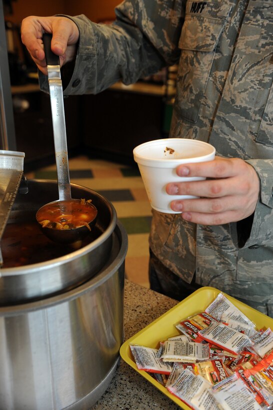Airman 1st Class Timothy Huff, 28th Aircraft Maintenance Squadron integrated avionics technician, chooses soup for his lunch at the new food kiosk in the 34th Bomb Squadron at Ellsworth Air Force Base, S.D., July 24, 2013. The kiosk offers a variety of meals for Airmen both with and without meal cards including two hot meal choices, cold subs, soup and an assortment of sides and snacks. (U.S. Air Force photo by Airman 1st Class Rebecca Imwalle/Released)