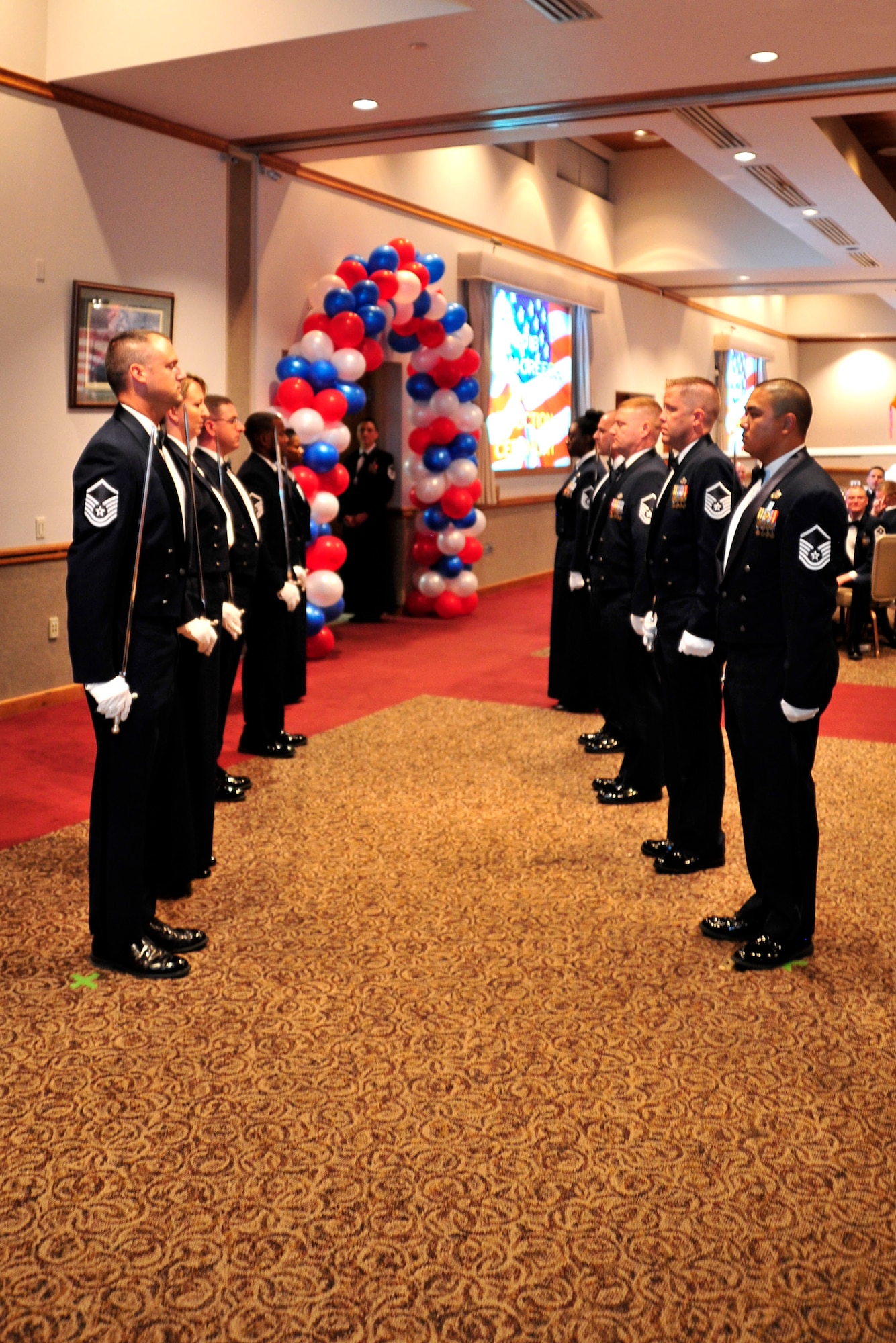 NELLIS AIR FORCE BASE, Nev. -- A team of senior noncommissioned officers prepare a saber arch during the Creech Air Force Base SNCO Induction Ceremony Aug. 2, 2013.  Inductees walk beneath the saber arch during the ceremony as a sign of honor and recognition for achieving the rank of master sergeant. (U.S. Air Force photo by 1st Lt. S.S./Released)
