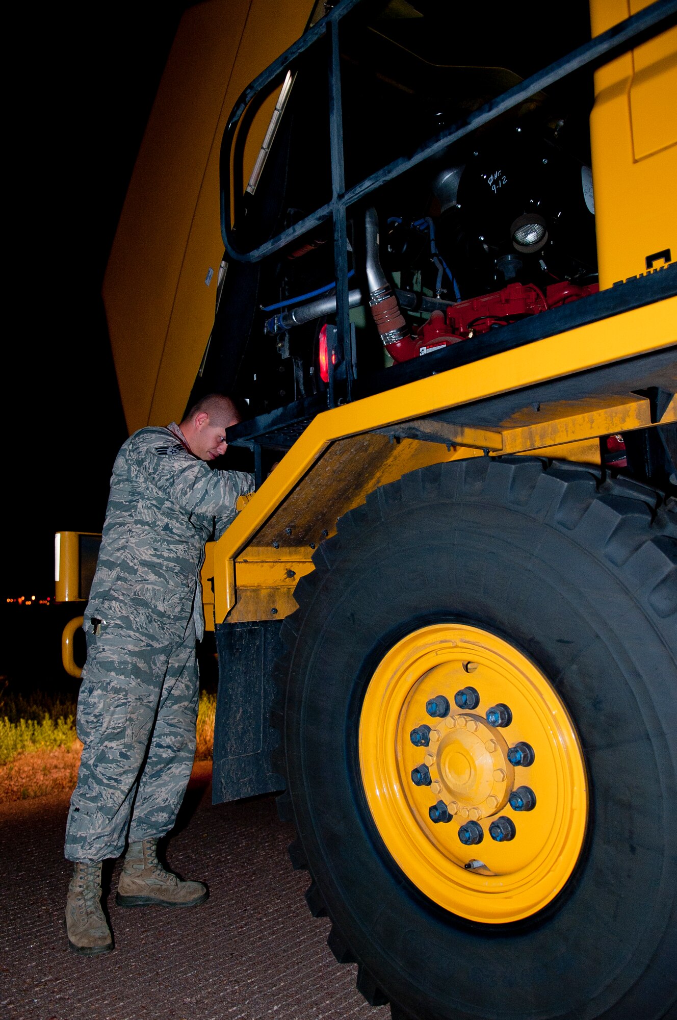 ALTUS AIR FORCE BASE, Okla. – U.S. Air Force Senior Airman Michael McCoy, 97th Civil Engineer Squadron pavement and heavy equipment operator, checks the oil levels of an Oshkosh street brush before a rubber removal on the flightline here, Aug. 2. Inspecting the equipment before use is important to ensuring the equipment functions properly and will perform the task at hand. (U.S. Air Force photo by Senior Airman Dillon Davis/Released)